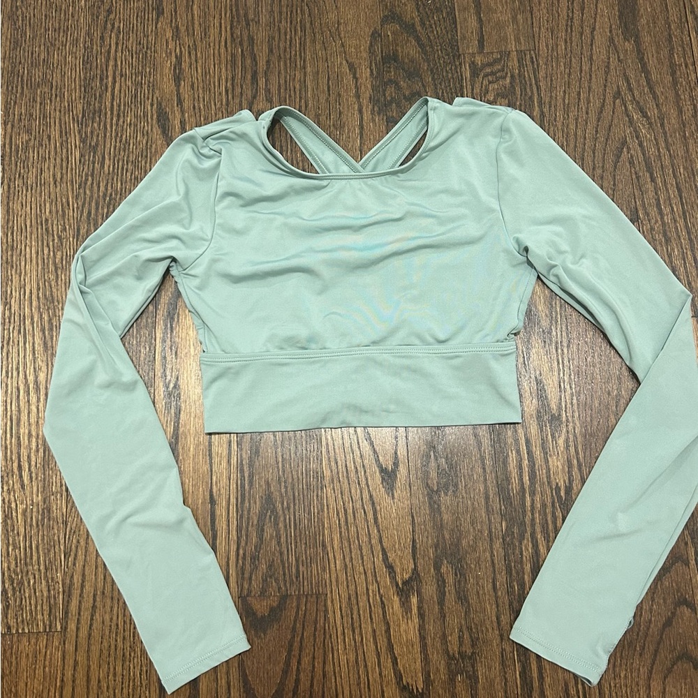 Green long sleeve workout top with crossed back and finger holds